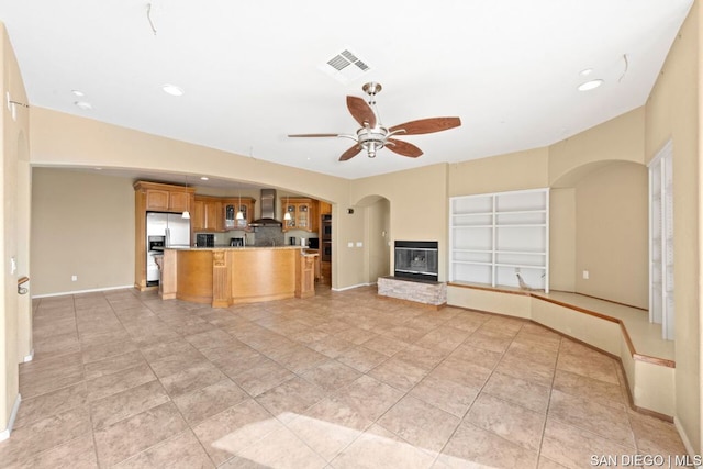 unfurnished living room with ceiling fan and light tile patterned floors