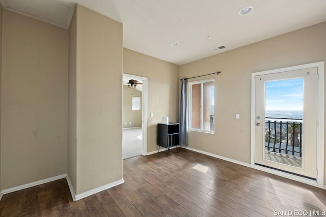 unfurnished room featuring dark wood-type flooring and ceiling fan