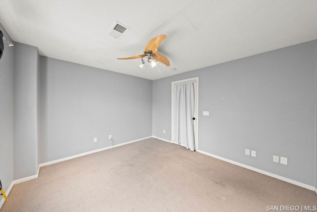 carpeted spare room featuring ceiling fan