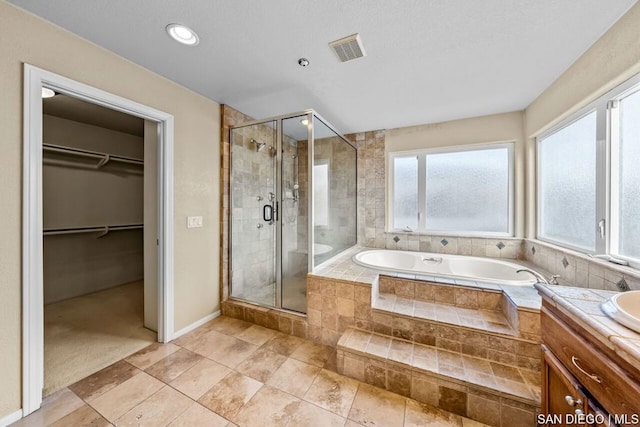 bathroom featuring vanity and plus walk in shower