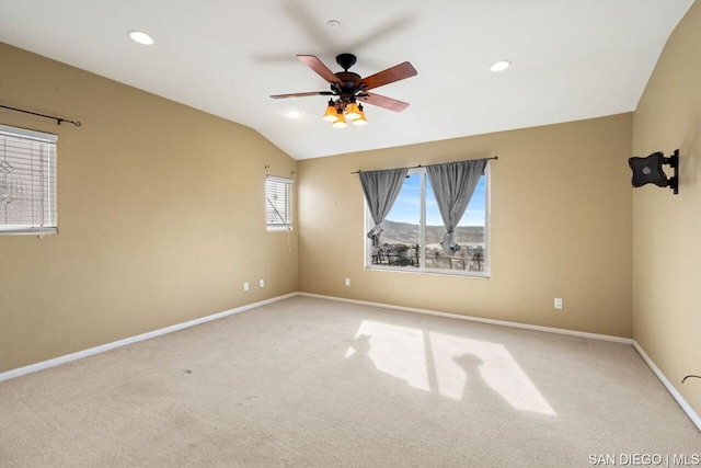 unfurnished room featuring lofted ceiling, light colored carpet, and ceiling fan