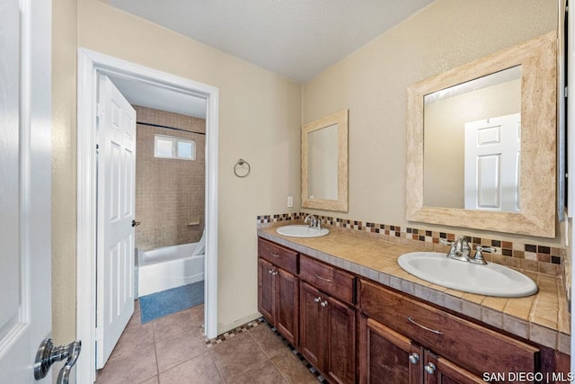 bathroom with tile patterned flooring, vanity, bathtub / shower combination, and decorative backsplash