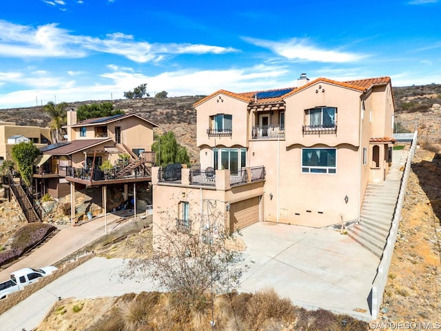 view of front of property with a balcony and a garage