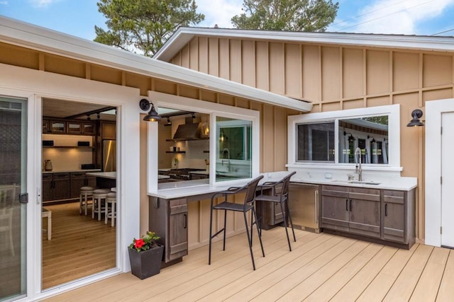 wooden terrace featuring an outdoor wet bar