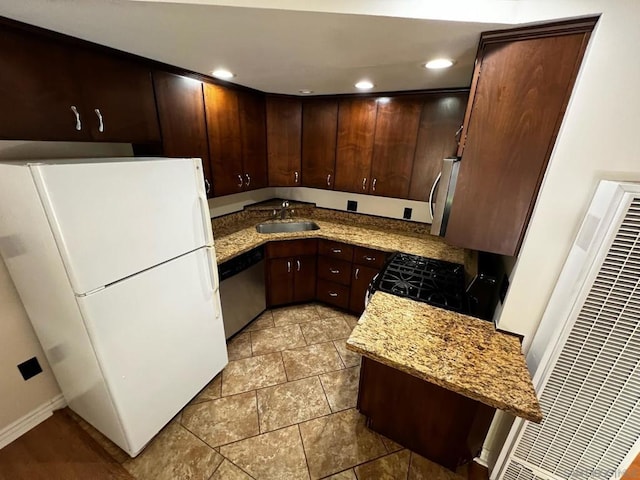 kitchen featuring light stone counters, sink, dark brown cabinets, and stainless steel appliances