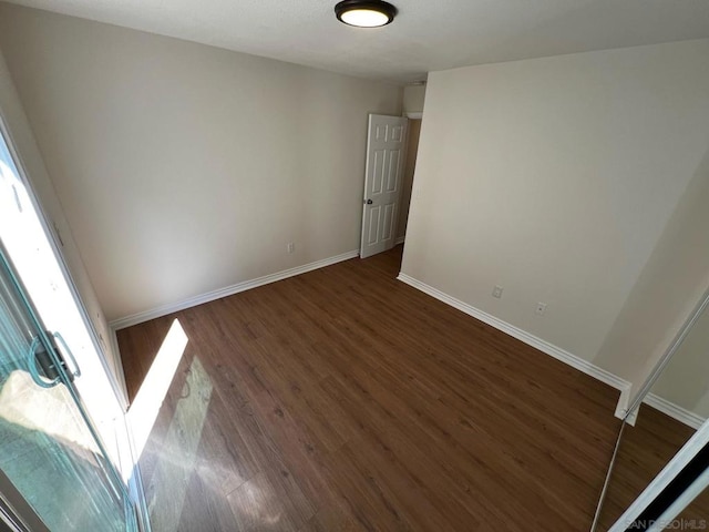 spare room featuring dark hardwood / wood-style flooring