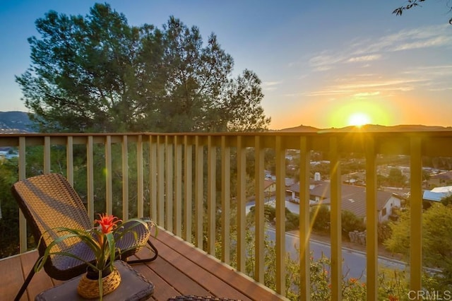 balcony at dusk with a deck with mountain view