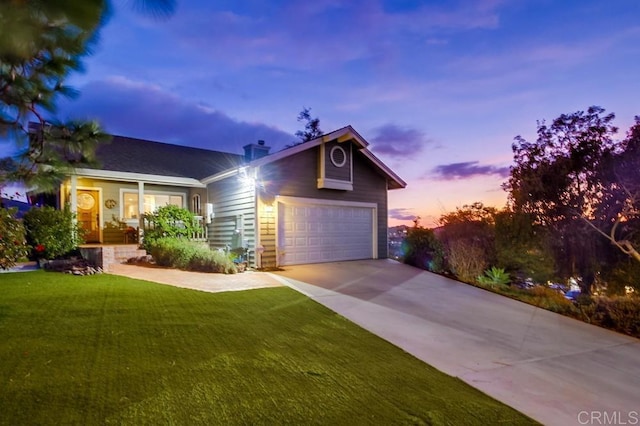 view of front facade with a garage and a lawn