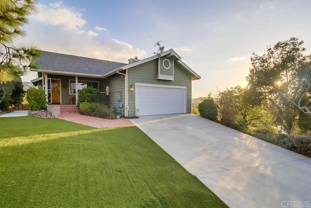 ranch-style home featuring a garage, a lawn, and a porch