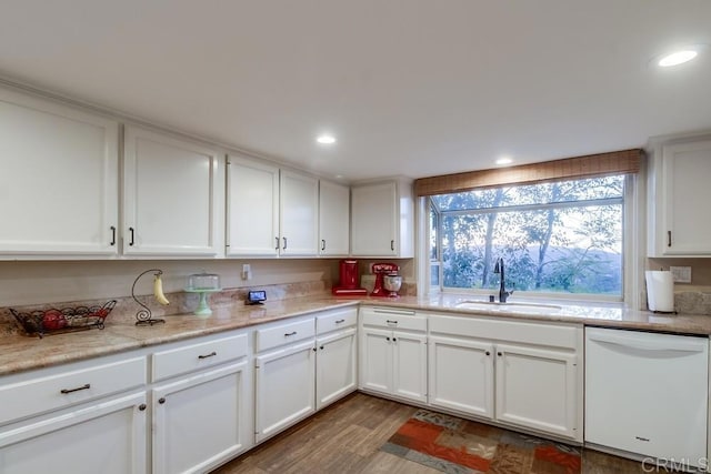 kitchen with white cabinetry, dark hardwood / wood-style flooring, sink, and white dishwasher