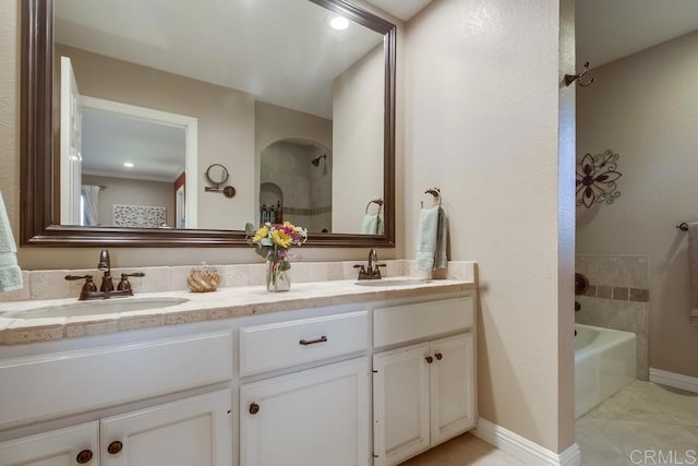 bathroom with vanity, tile patterned flooring, and a tub