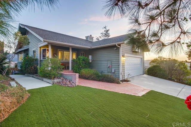 ranch-style house with a garage and a lawn