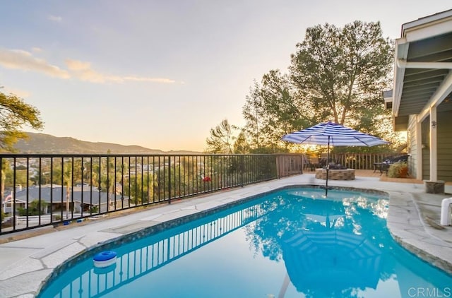 pool at dusk with a mountain view