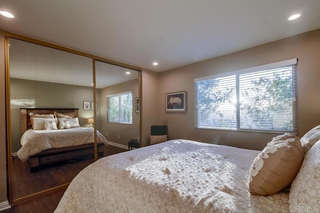 bedroom with hardwood / wood-style flooring and a closet