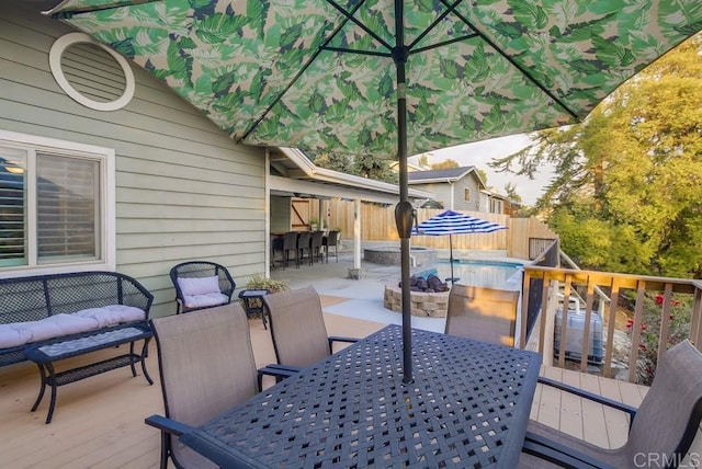 deck featuring an outdoor living space and a fenced in pool