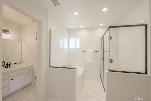 bathroom featuring vanity and separate shower and tub