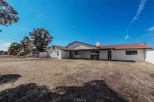 rear view of property with a yard