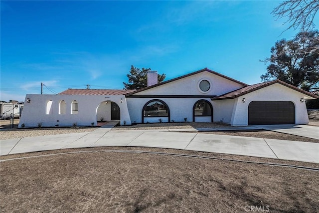 mediterranean / spanish home with a garage