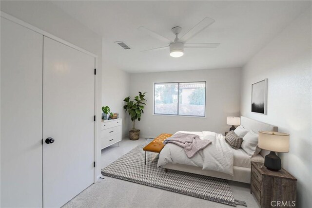 bedroom with light colored carpet and ceiling fan