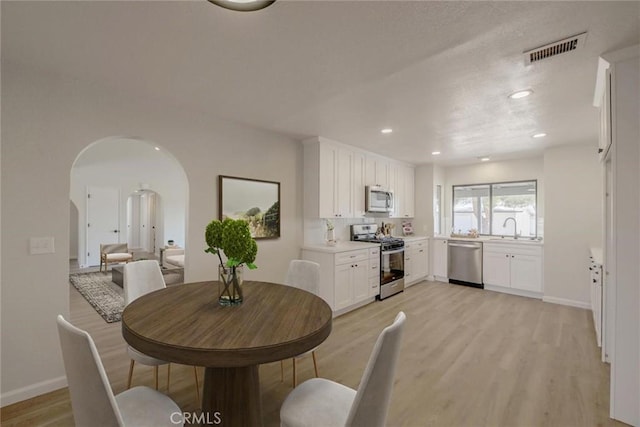 dining room featuring light hardwood / wood-style floors and sink