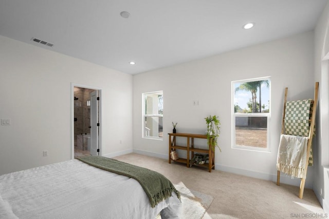 carpeted bedroom featuring ensuite bath