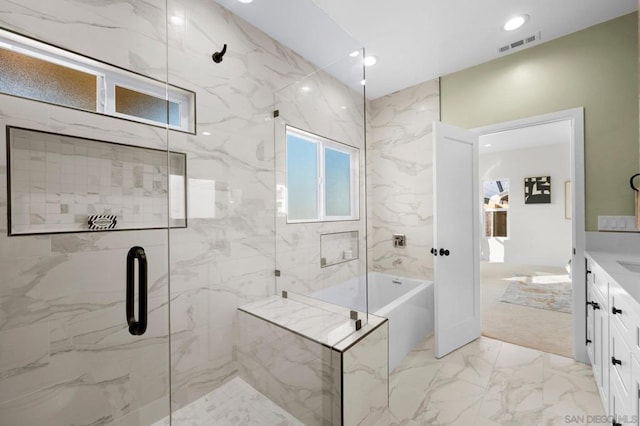 bathroom featuring vanity and separate shower and tub