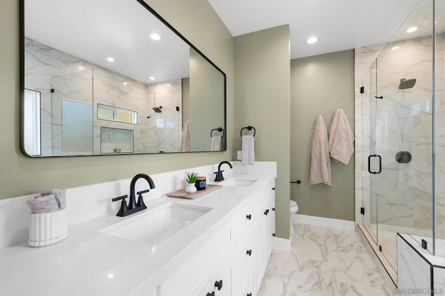 bathroom featuring vanity, toilet, and a shower with door