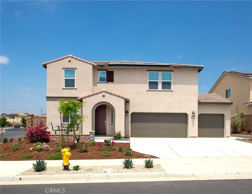 mediterranean / spanish-style home with a garage