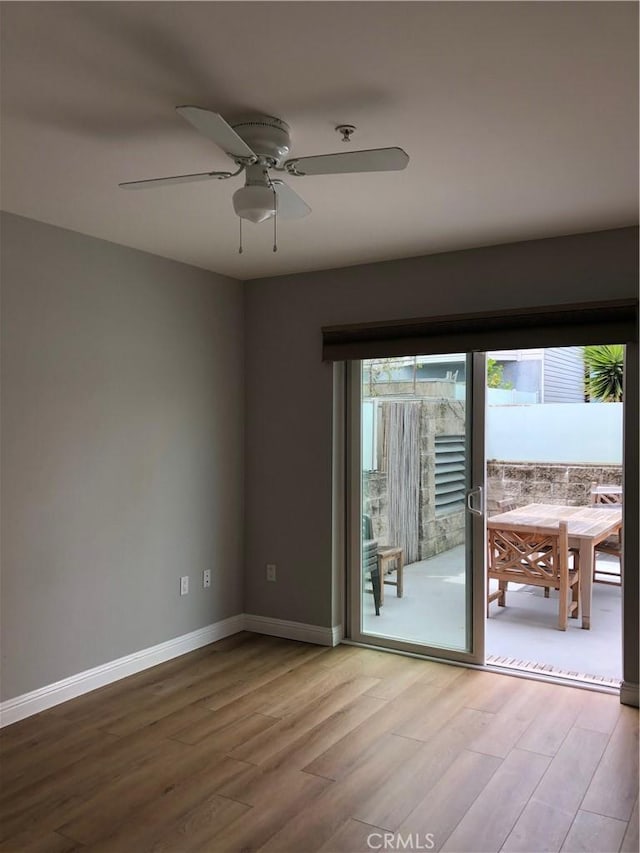 spare room featuring hardwood / wood-style flooring and ceiling fan