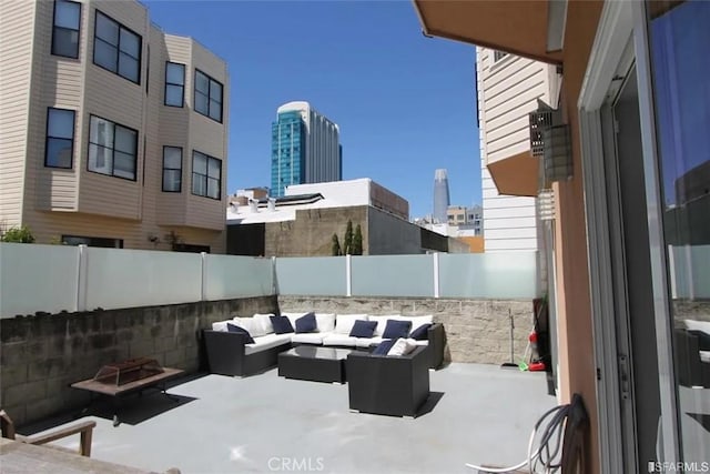 view of patio featuring an outdoor living space with a fire pit