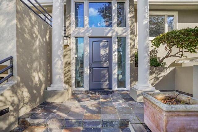 view of exterior entry featuring a patio area