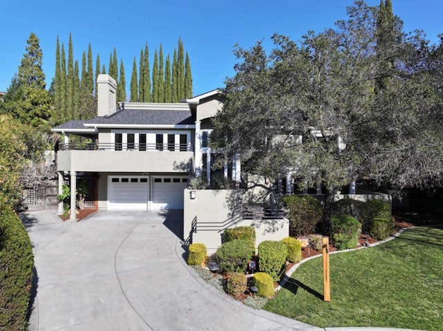 view of front of home featuring a garage and a front lawn