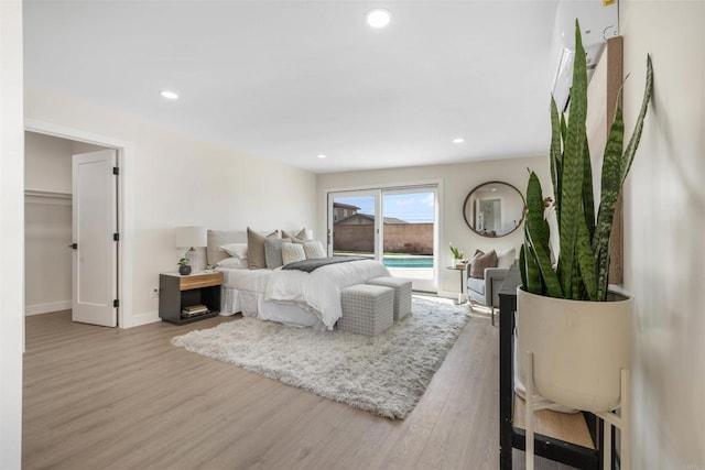 bedroom with access to exterior and light hardwood / wood-style floors