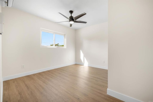 spare room with ceiling fan and light wood-type flooring