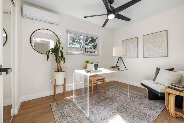 home office featuring wood-type flooring, a wall mounted air conditioner, and ceiling fan