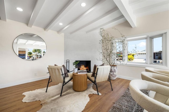 interior space with light hardwood / wood-style flooring, beam ceiling, and a high end fireplace