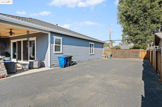 view of side of home featuring ceiling fan and a patio