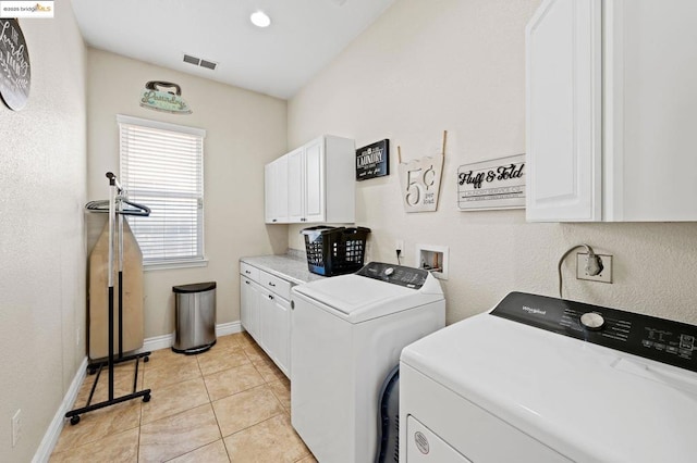 washroom featuring cabinets, independent washer and dryer, and light tile patterned flooring