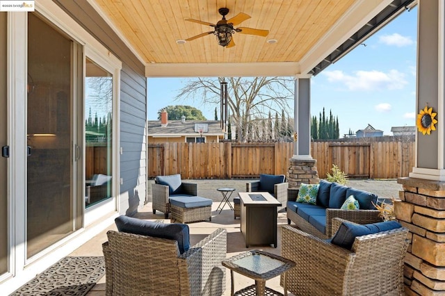 view of patio / terrace with an outdoor living space with a fire pit and ceiling fan