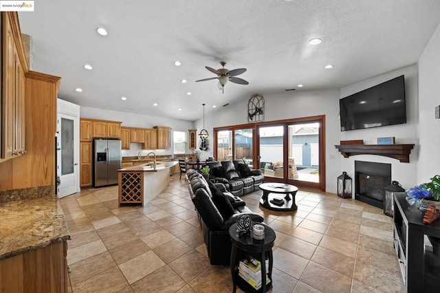 tiled living room featuring vaulted ceiling and ceiling fan