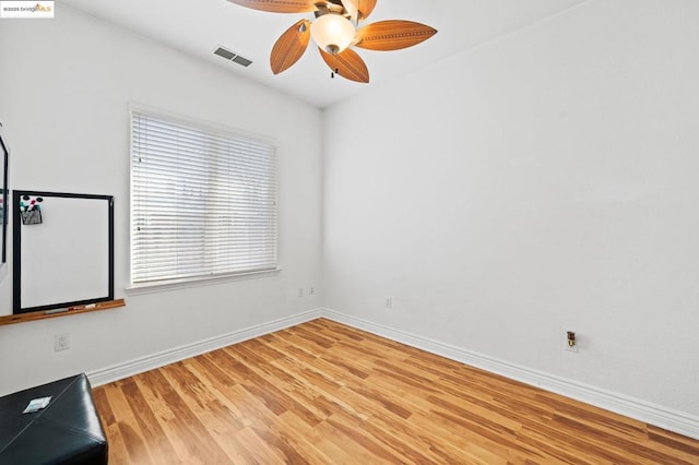 spare room featuring ceiling fan and hardwood / wood-style floors