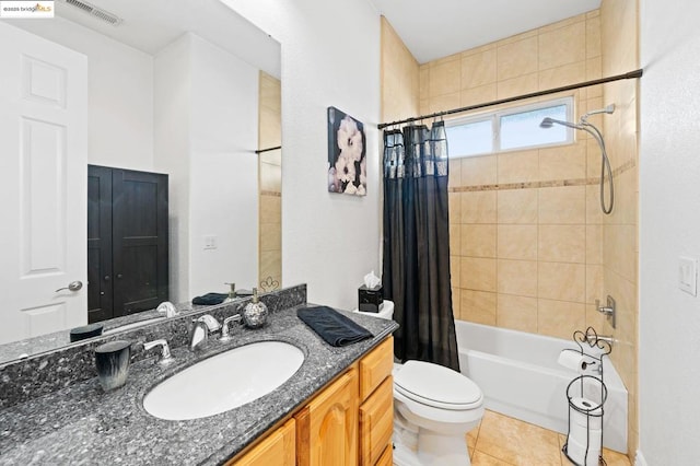 full bathroom featuring vanity, shower / bathtub combination with curtain, tile patterned floors, and toilet