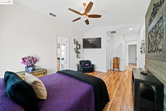 bedroom with vaulted ceiling, ensuite bath, ceiling fan, and hardwood / wood-style floors