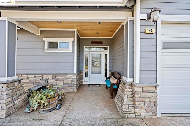 view of exterior entry with a garage