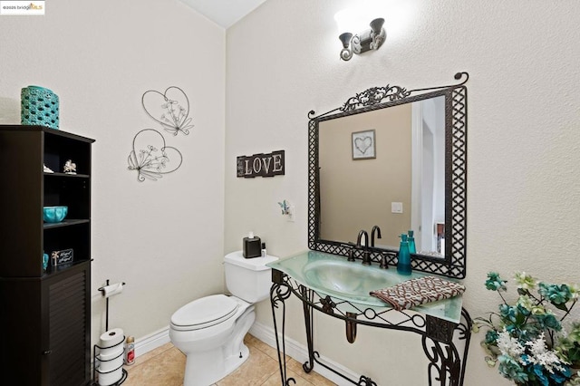 bathroom featuring sink, tile patterned floors, and toilet