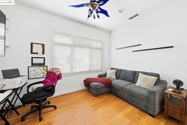 office with hardwood / wood-style floors and ceiling fan