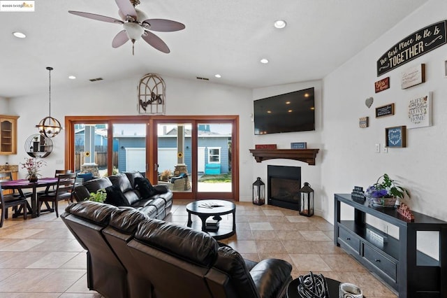 tiled living room featuring lofted ceiling and ceiling fan with notable chandelier