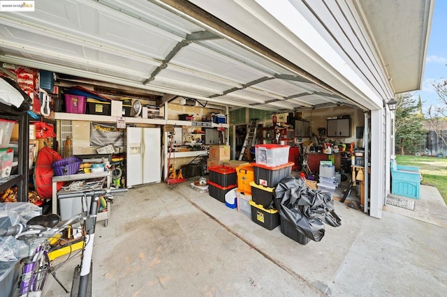 garage with a workshop area and white fridge with ice dispenser