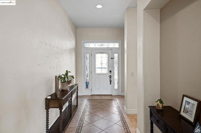 foyer entrance featuring light tile patterned flooring