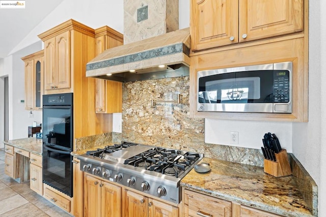 kitchen featuring decorative backsplash, stainless steel appliances, light stone countertops, custom range hood, and light brown cabinets